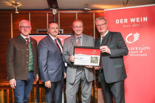Biosphärenpark Direktor DI Andreas Weiß (l.), Wiener LAbg. Ernst Holzmann (2.v.l.) und NÖ LAbg. Christoph Kainz (r.) gratulieren dem Weingut Schaflerhof zum Kategoriesieg Rotwein mit Holz.