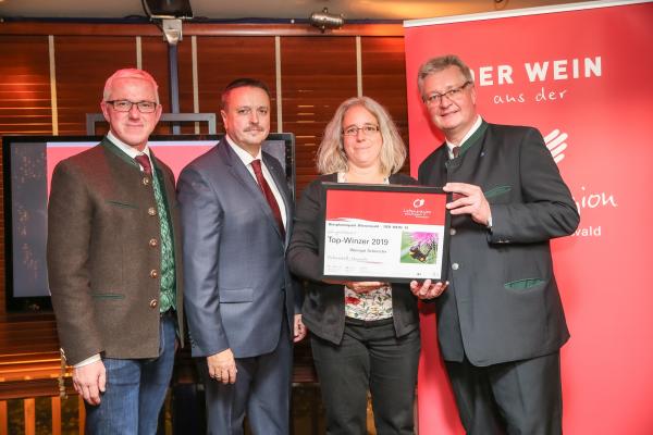 Biosphärenpark Direktor DI Andreas Weiß (l.), Wiener LAbg. Ernst Holzmann (2.v.l.) und NÖ LAbg. Christoph Kainz (r.) gratulieren dem Weingut Schneider zum Top-Winzer 2019.